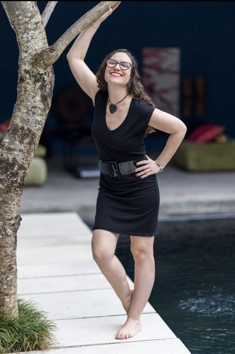 Bia Bliss standing beside a tree